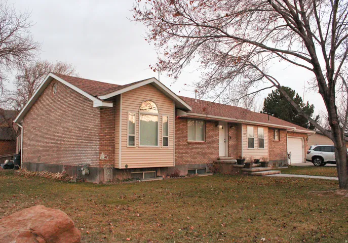 Brick and siding exterior residence featuring a prominent bay window