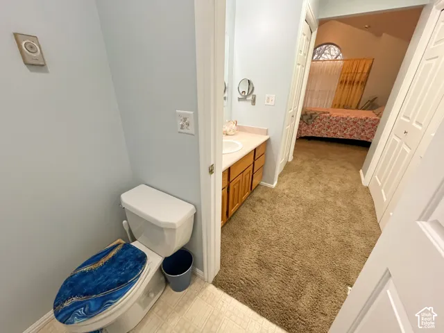 Vanity with light wood-finish cabinetry and white countertop