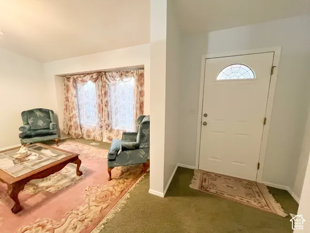 White entry door with an arched decorative glass insert and brass hardware