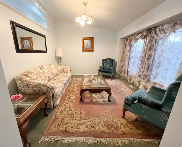 Spacious room featuring vaulted ceilings and a chandelier light fixture