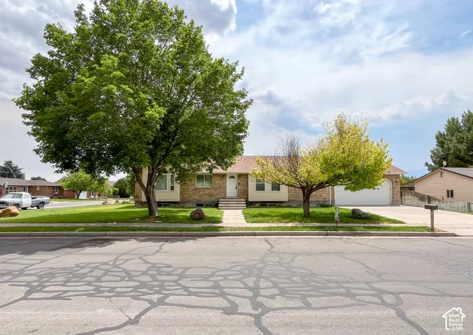 Brick-front residence with a two-car garage and a paved driveway