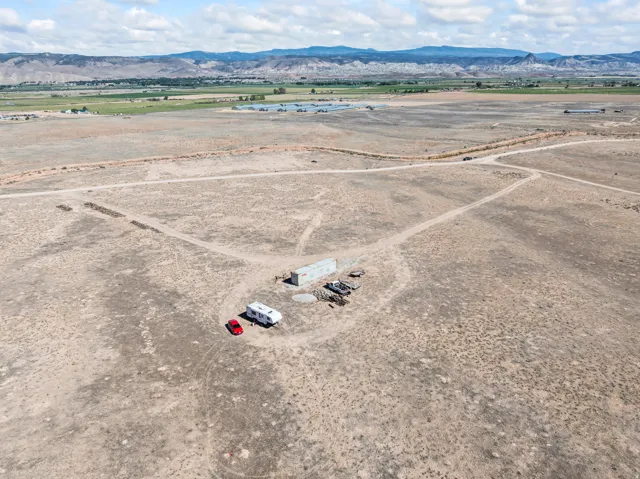Expansive arid terrain with a distant mountainous backdrop
