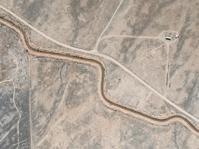 Aerial Map. Depicting a rural landscape with an irrigation canal, unimproved roads, and a structure
