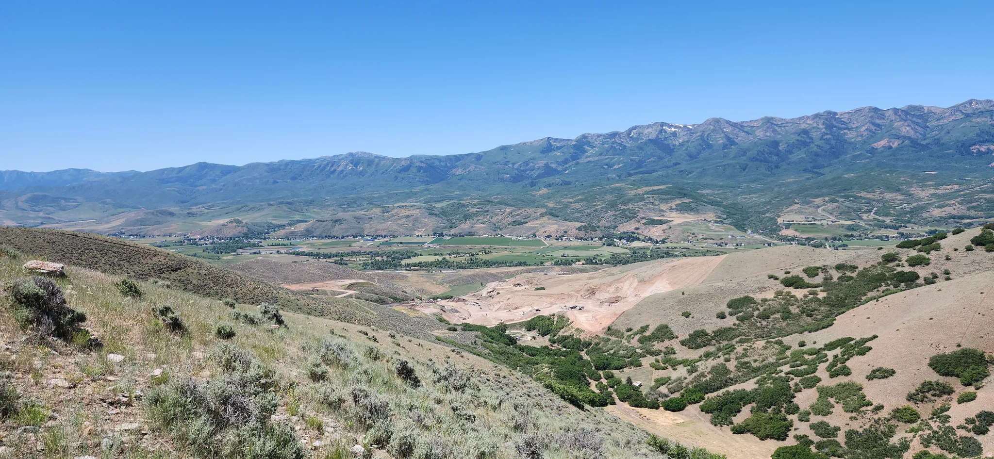 Expansive mountain and valley scenery under a clear sky
