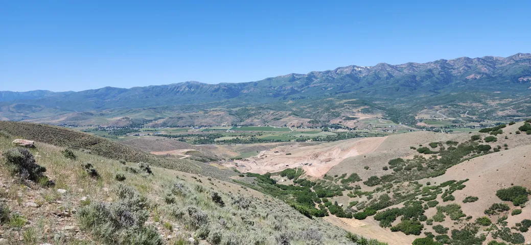 Expansive mountain and valley scenery under a clear sky
