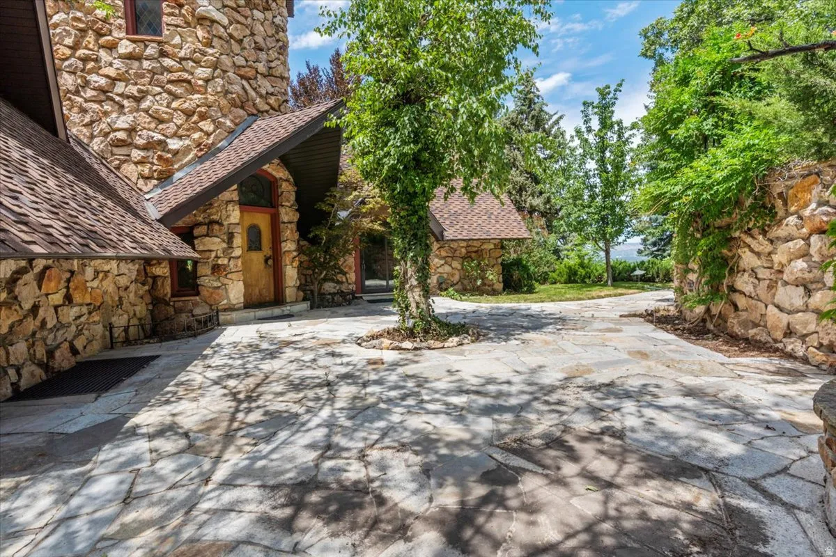 Stone exterior residence with a flagstone driveway