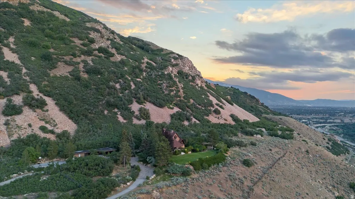 Mountainside property featuring extensive natural landscaping and a distinct architectural style
