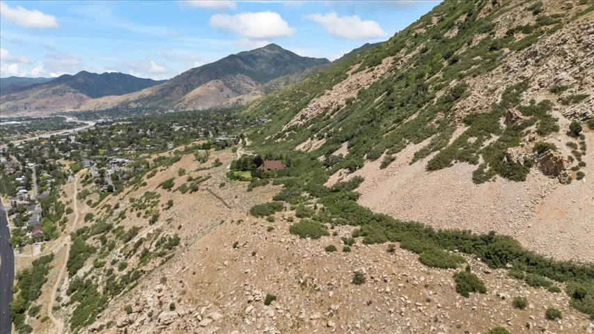 Expansive mountain landscape with a residential area and distant structures