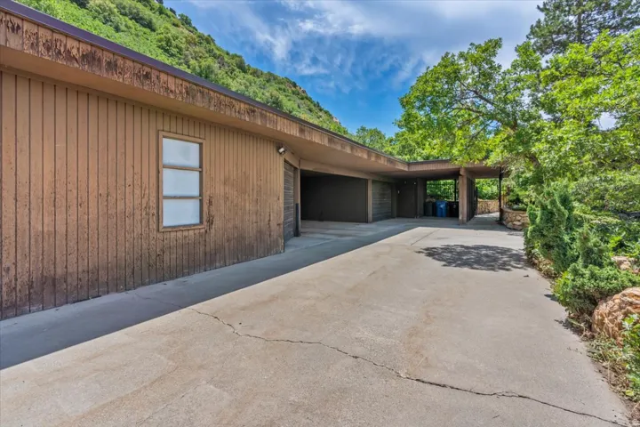 Expansive concrete driveway accessing a covered entryway and attached garage