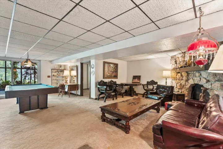 Spacious lower-level area with carpeting and a drop ceiling