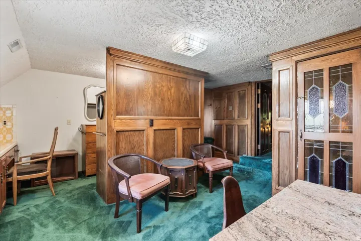 Warm wood paneling and cabinetry create a traditional aesthetic