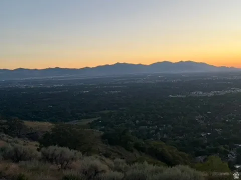Expansive mountain range backdrop framing a verdant valley below