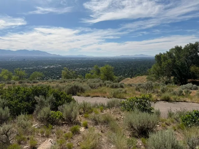 Expansive mountain and city scenery with a blue sky overhead