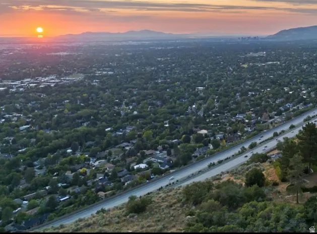 Expansive aerial perspective showcasing a widespread residential area and a prominent multi-lane highway