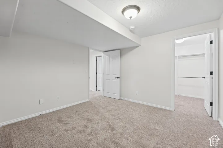 Neutral-toned carpet flooring with white walls