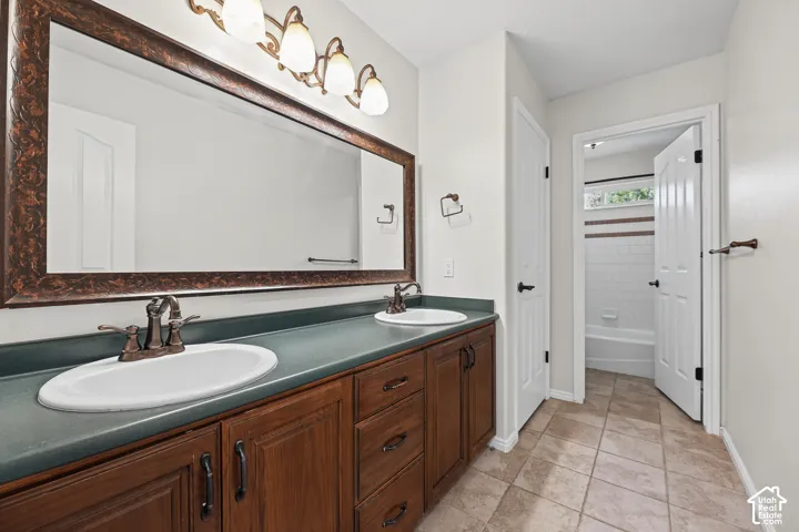 Dual vanity with dark wood-finish cabinetry and bronze hardware