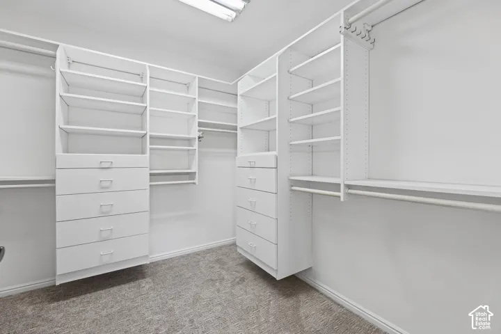 Built-in closet system featuring shelving, drawers, and hanging rods