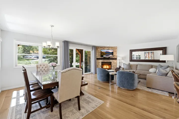 Spacious open-concept living area featuring light wood-finish flooring