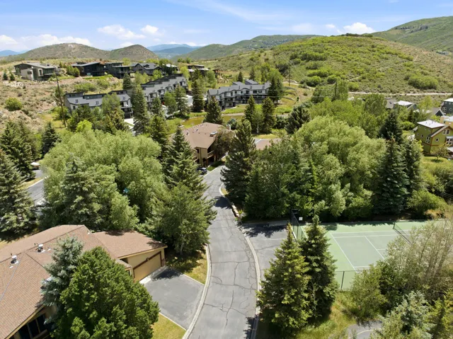 Residential development featuring multiple structures and abundant mature trees