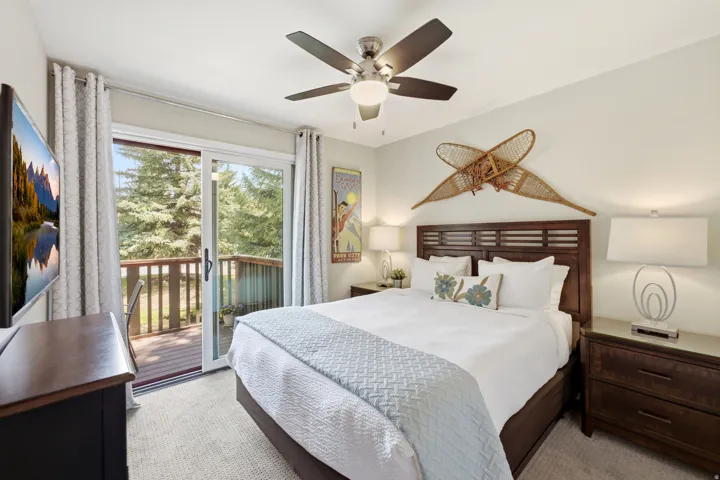 Bedroom featuring sliding glass door access to a private wooden deck