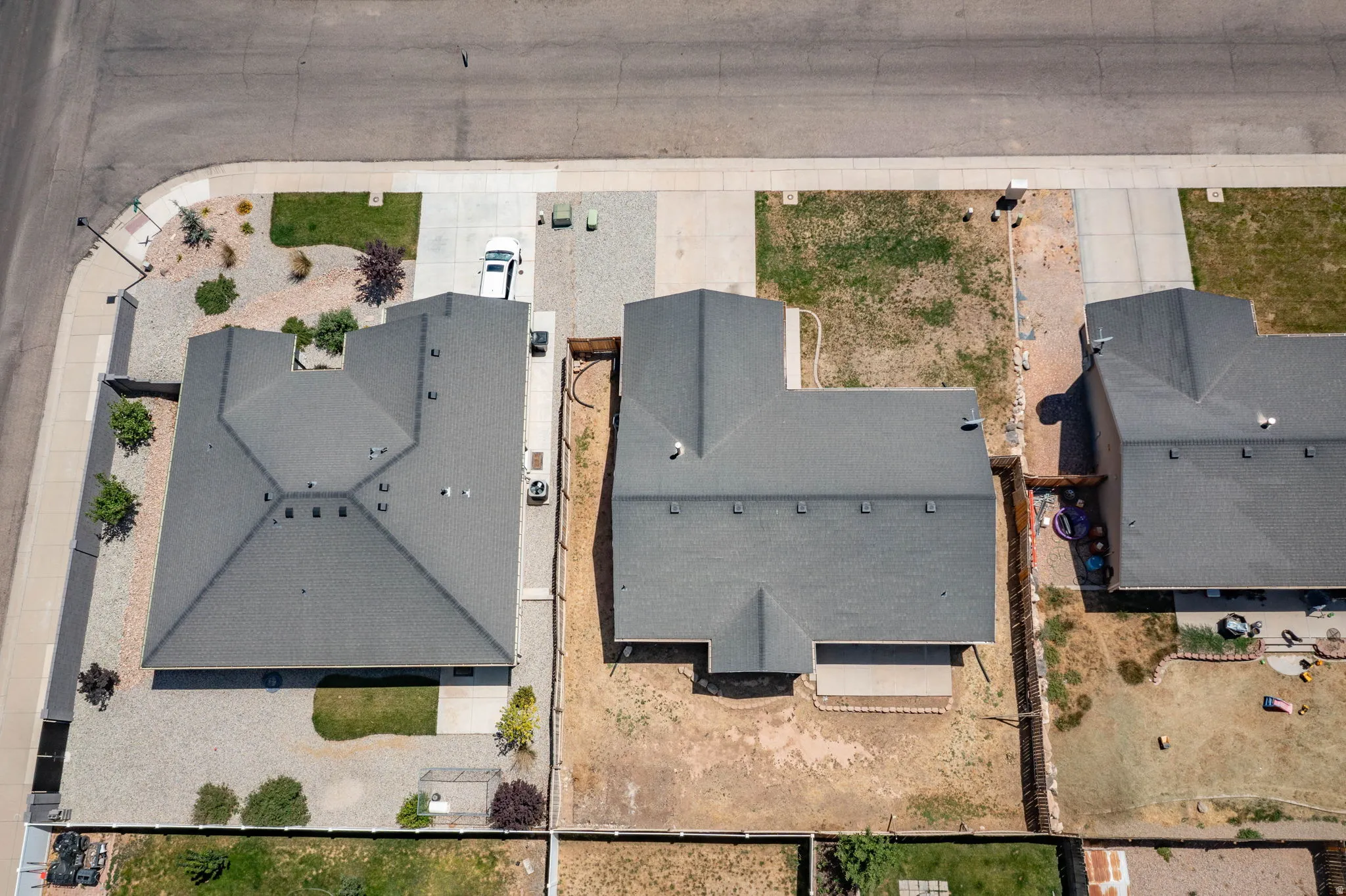 Contemporary residential property featuring an asphalt shingle roof, attached garage, and a concrete driveway