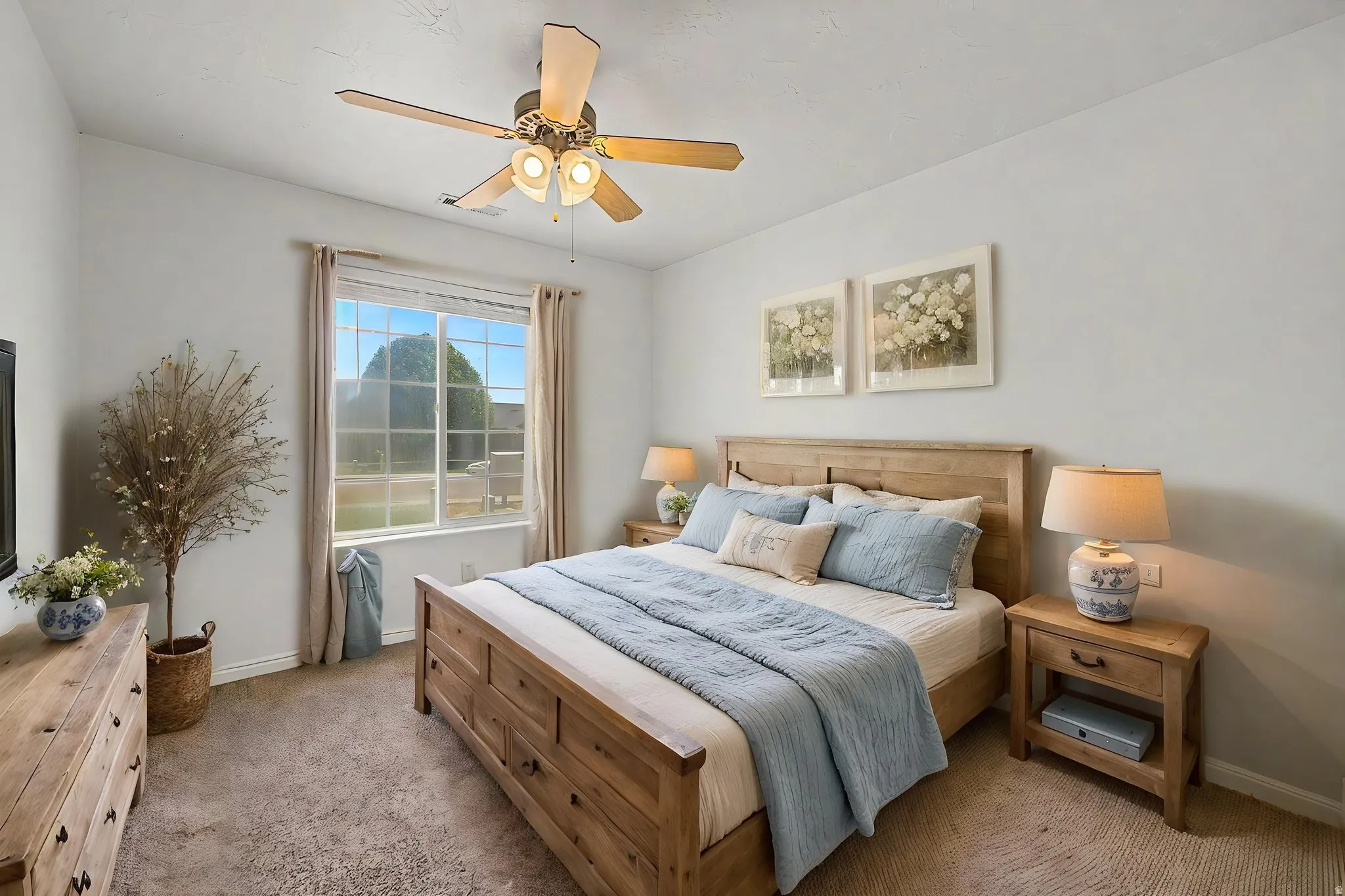 Carpeted room featuring a ceiling fan with integrated lighting, a large window with vertical blinds, and a built-in closet with a sliding door