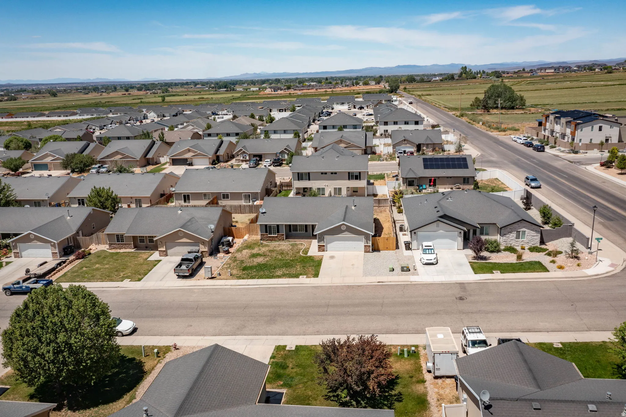 Residential neighborhood featuring single-story homes with attached garages and paved driveways