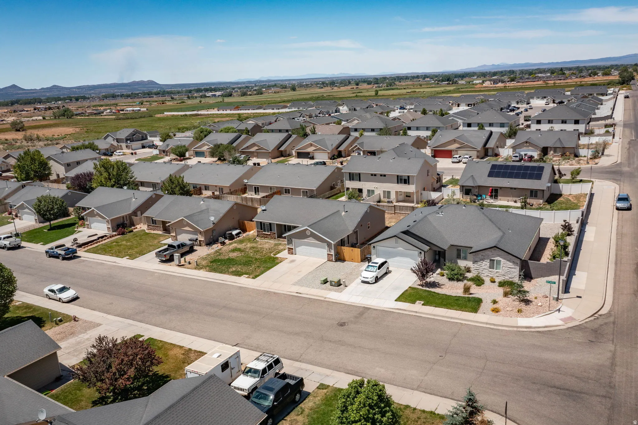 Residential neighborhood featuring single-family homes with pitched roofs and attached garages