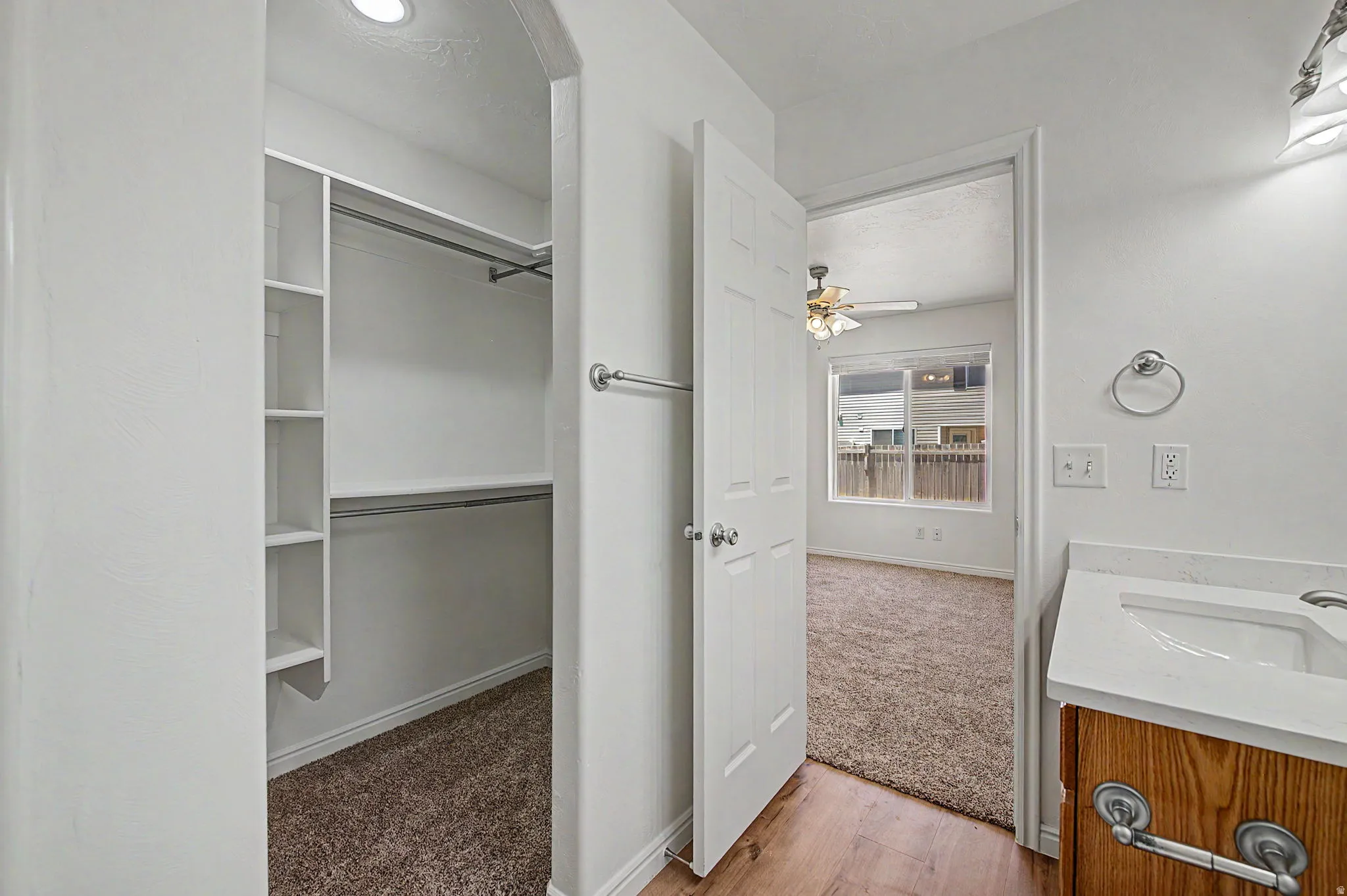 Walk-in closet with integrated shelving and hanging rods