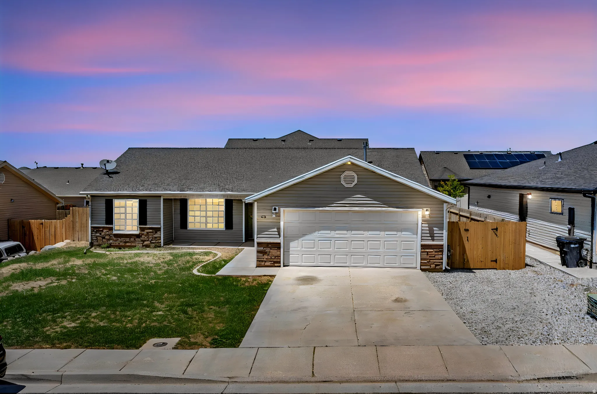 Single-story residence featuring horizontal siding and stone accents on the facade