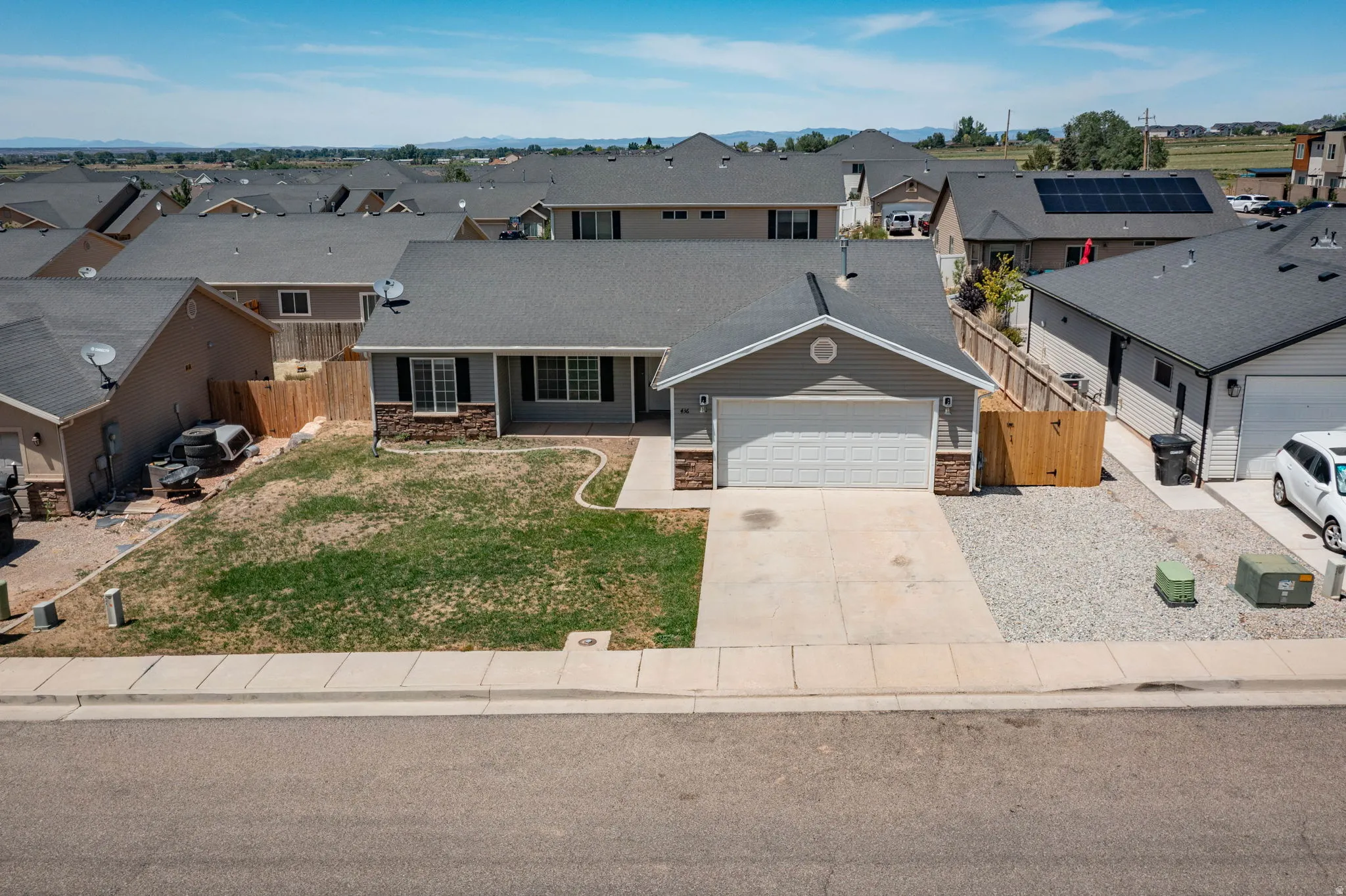 Single-story residence featuring a two-car garage, concrete driveway, and stone accents