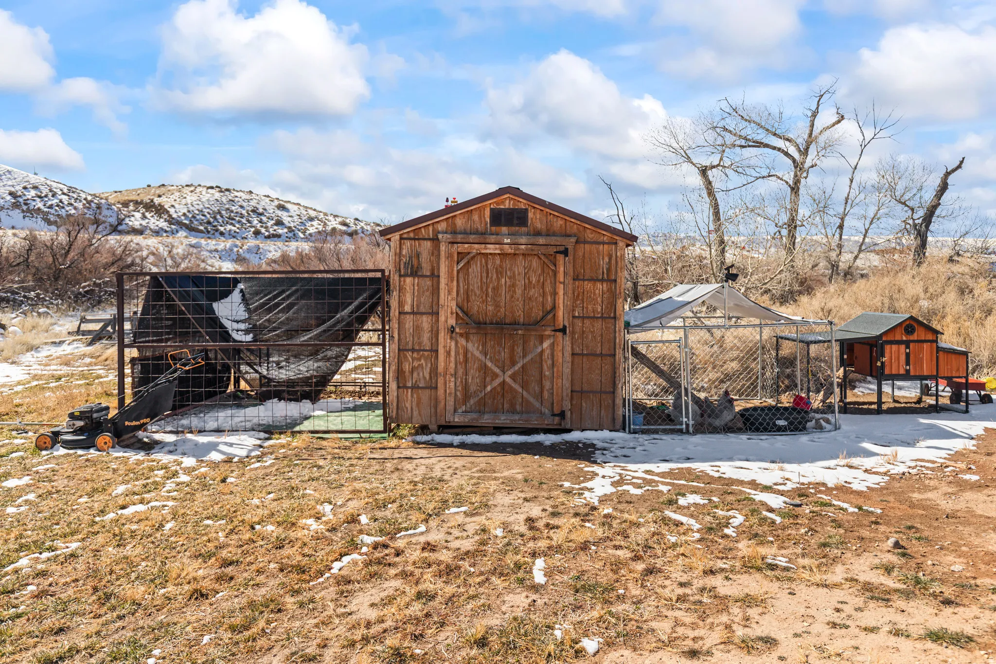 Wood-paneled storage shed with a gable roof