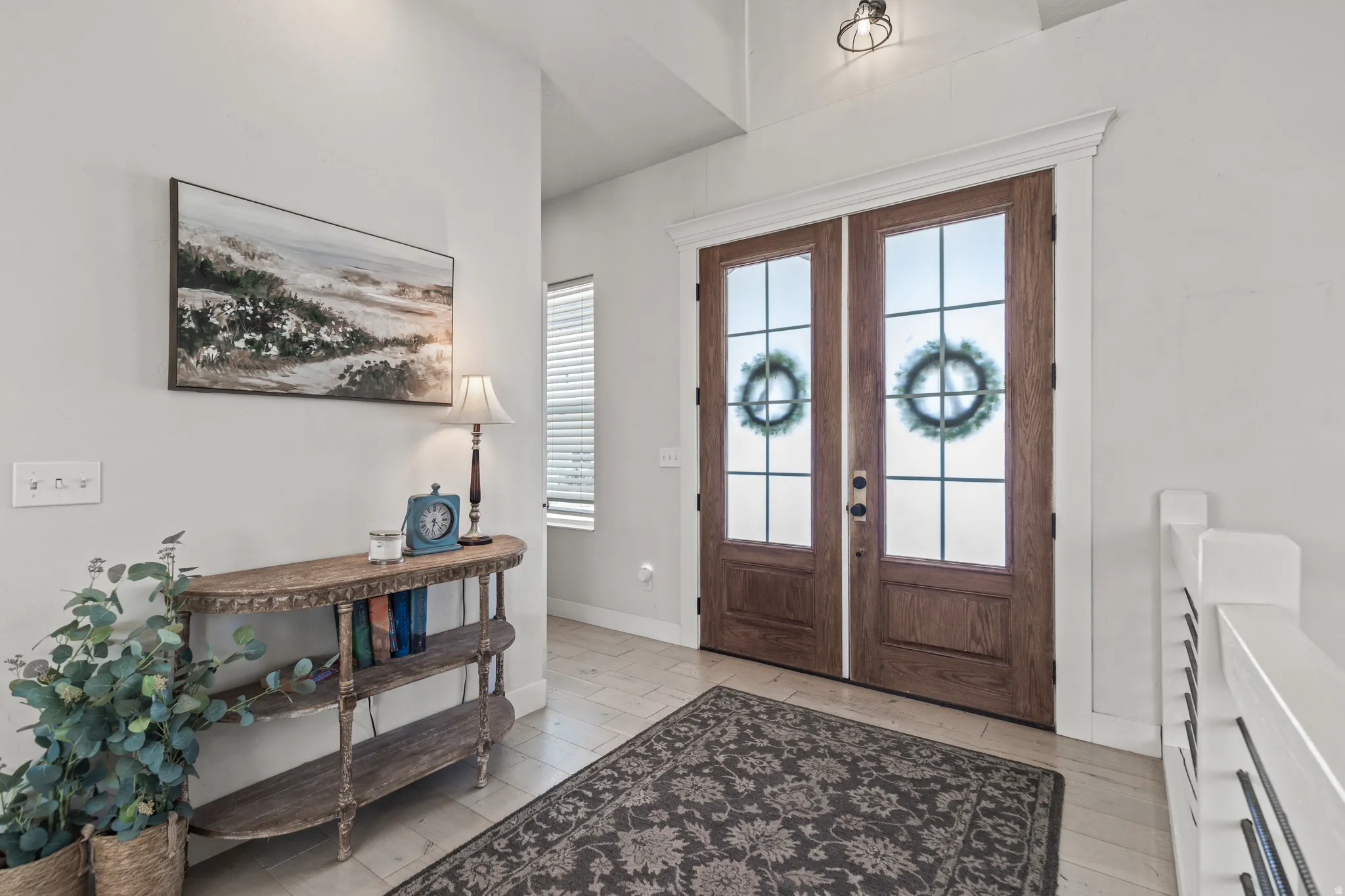 Double wood-finish entry doors with frosted glass panels and grid accents