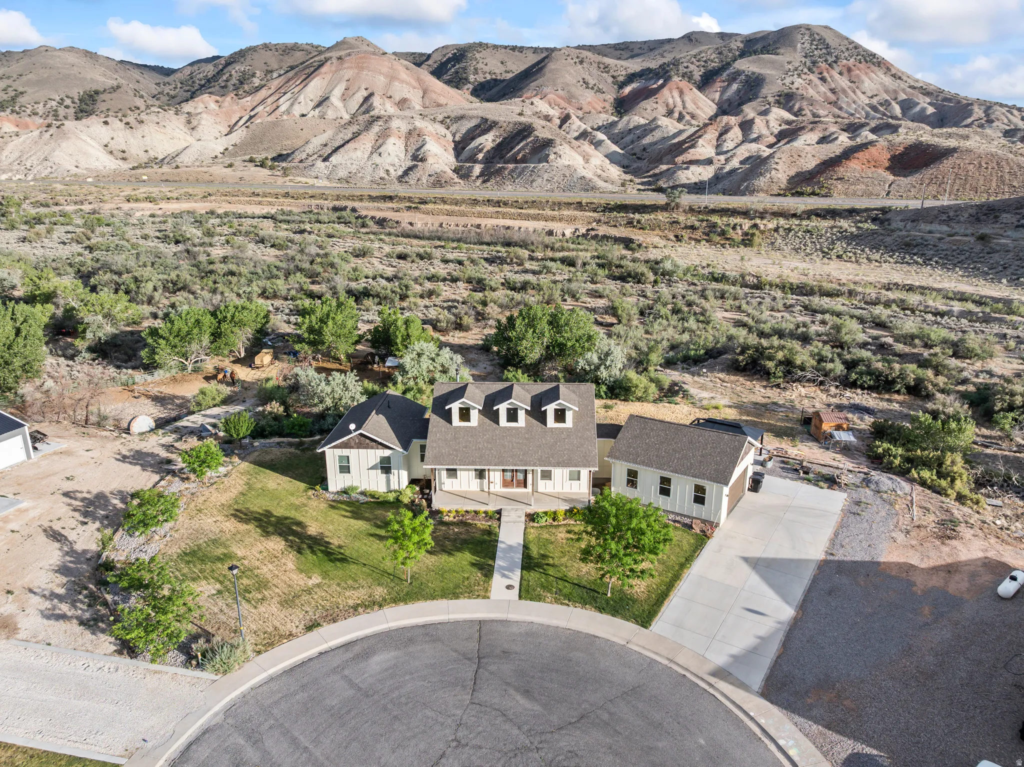 Single-family residence featuring a prominent dormer roofline and a detached garage