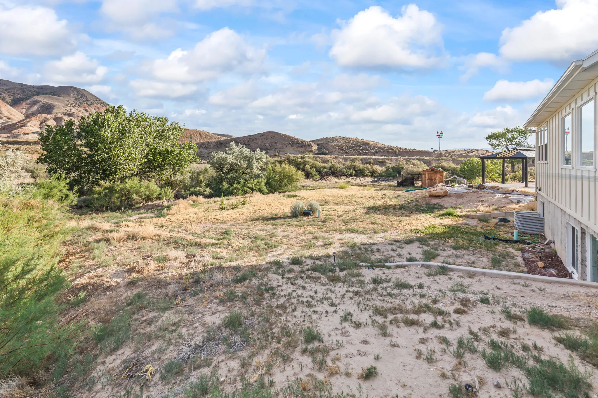Expansive outdoor space featuring natural landscaping with mature trees and native vegetation