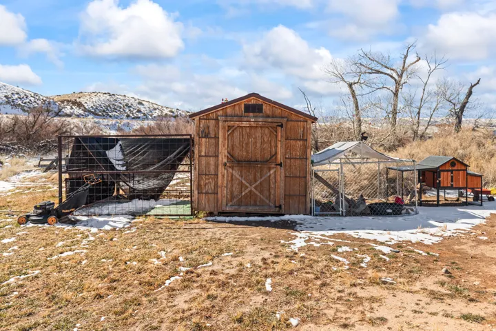 Wood-paneled storage shed with a gable roof