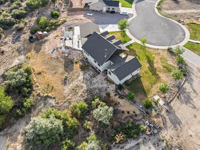 Modern residential property featuring a multi-level design and a dark shingle roof