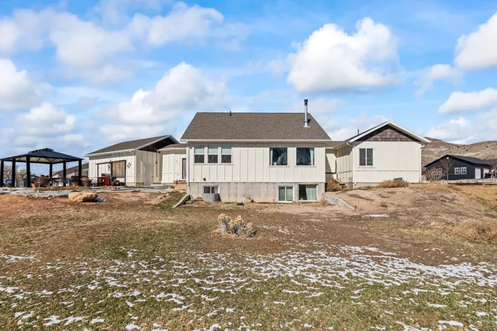 Spacious property featuring a main residence with a lower-level walk-out, an attached garage structure, and a detached outbuilding