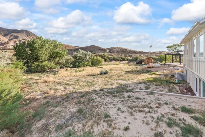 Expansive outdoor space featuring natural landscaping with mature trees and native vegetation
