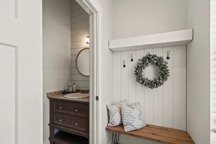 Built-in mudroom bench with shiplap backing and wall hooks