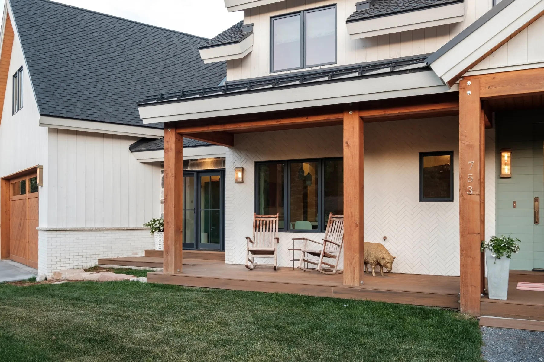 Covered front porch with substantial wood columns and matching wood-finish flooring