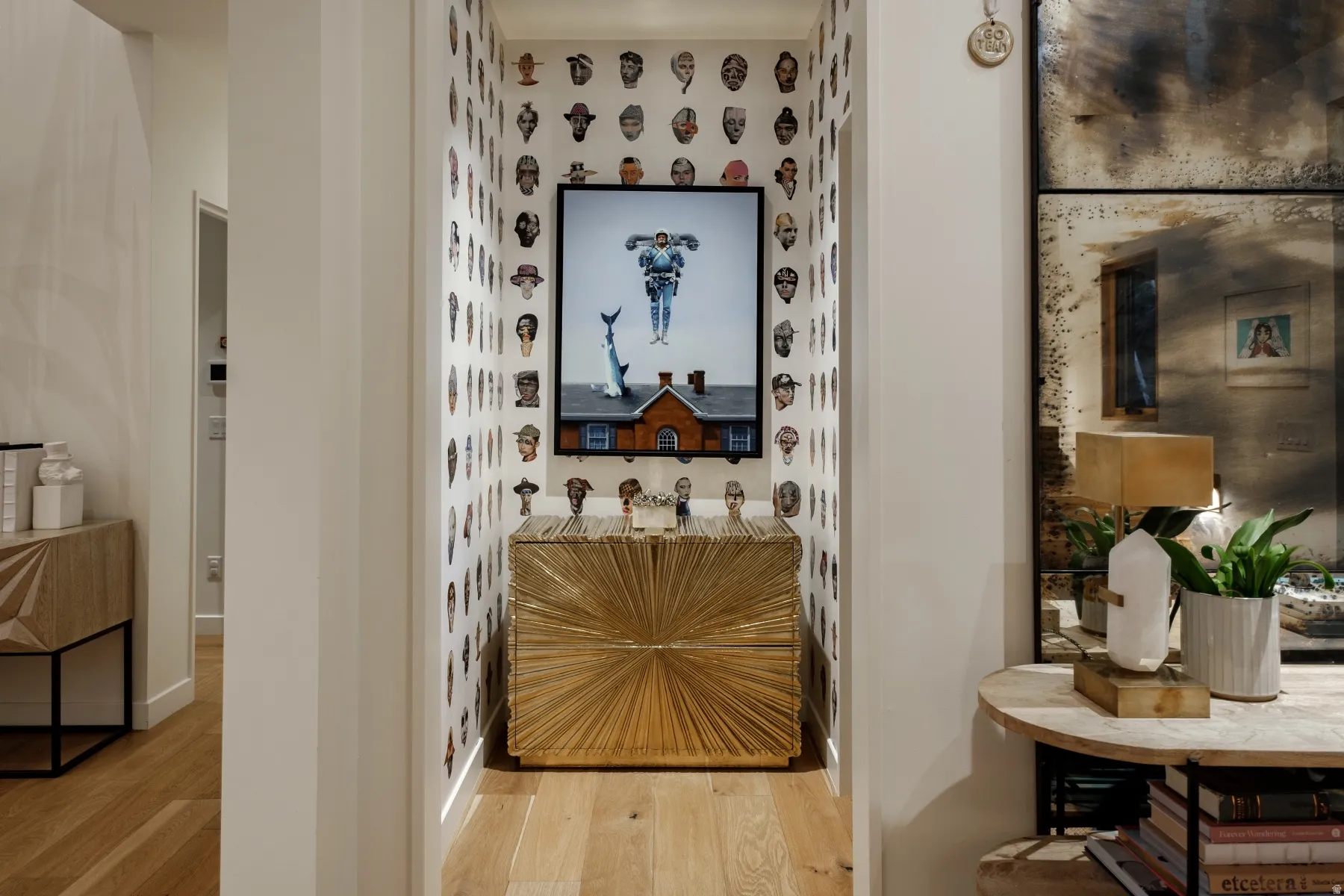 Recessed alcove featuring decorative wallpaper and light wood-finish flooring