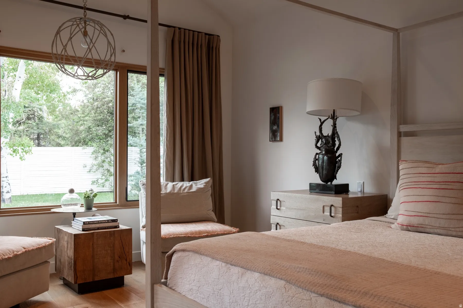 Wood-finish flooring with a large window featuring natural wood trim