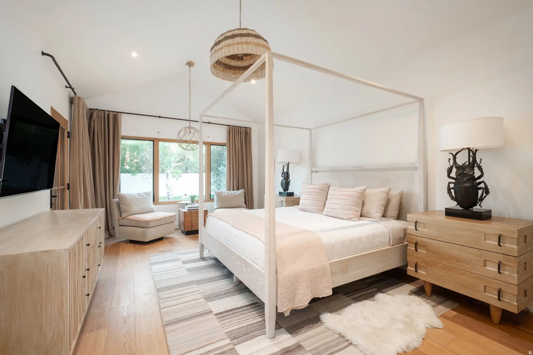 Vaulted ceilings with recessed lighting and a decorative pendant light fixture