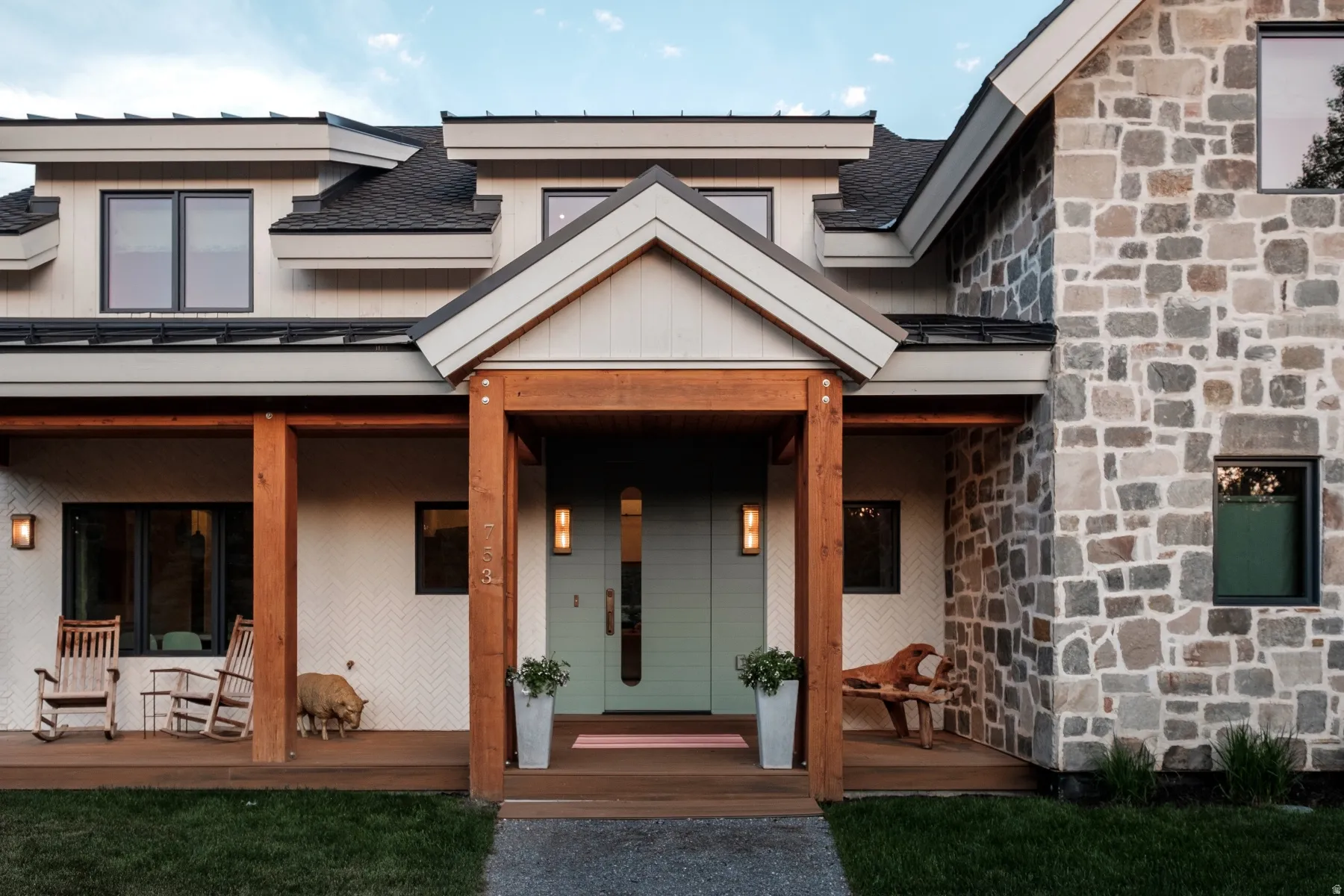 Modern exterior featuring mixed materials including stone veneer, horizontal siding, and textured paneling