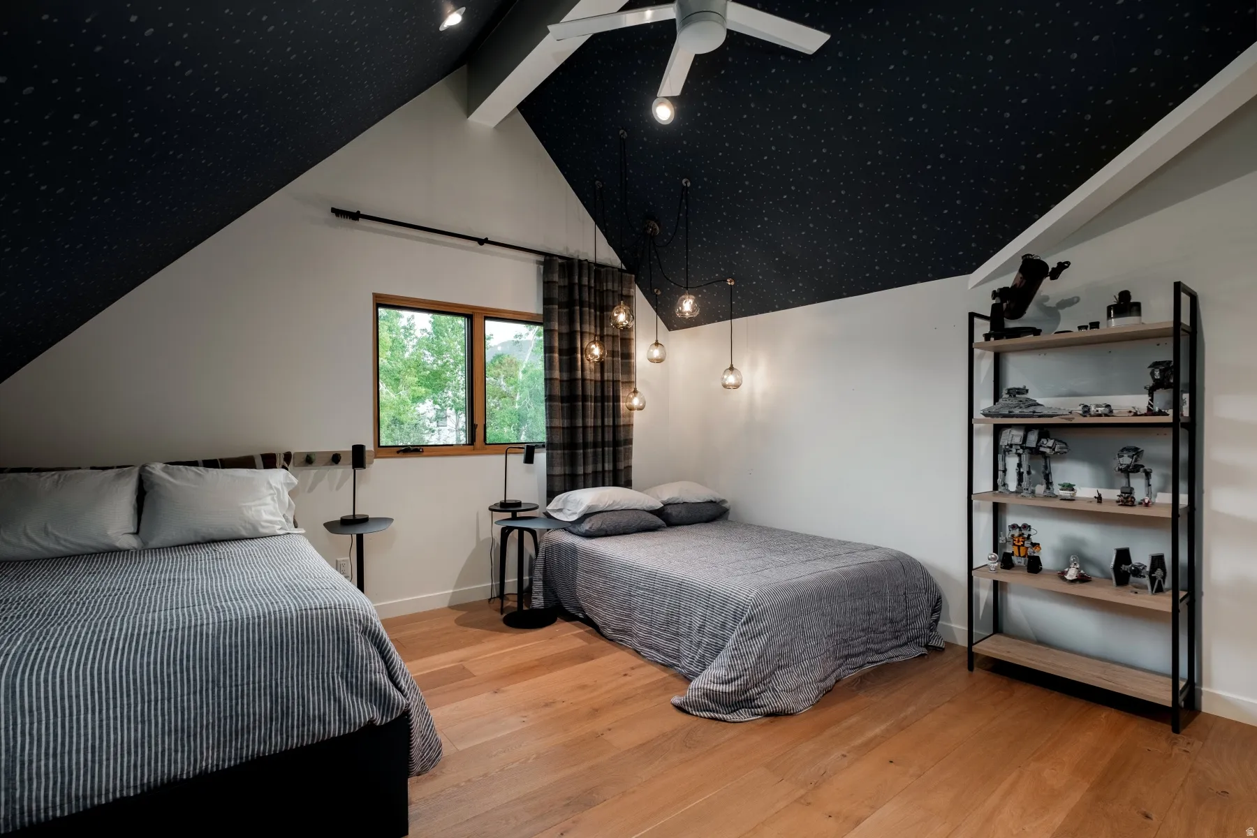 Vaulted ceiling with dark finish, light wood-finish flooring, recessed lighting, and a ceiling fan