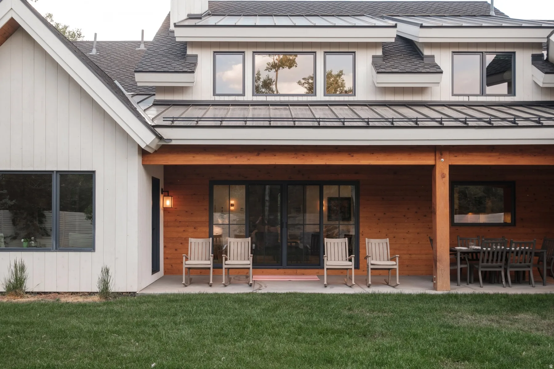 Expansive covered patio featuring natural wood paneling, wood support beams, and a concrete surface