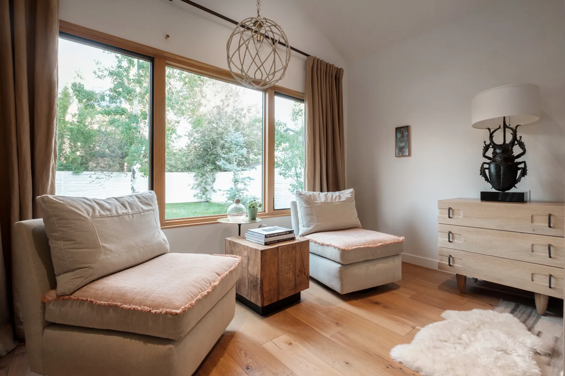 Hardwood flooring throughout featuring a vaulted ceiling and expansive windows