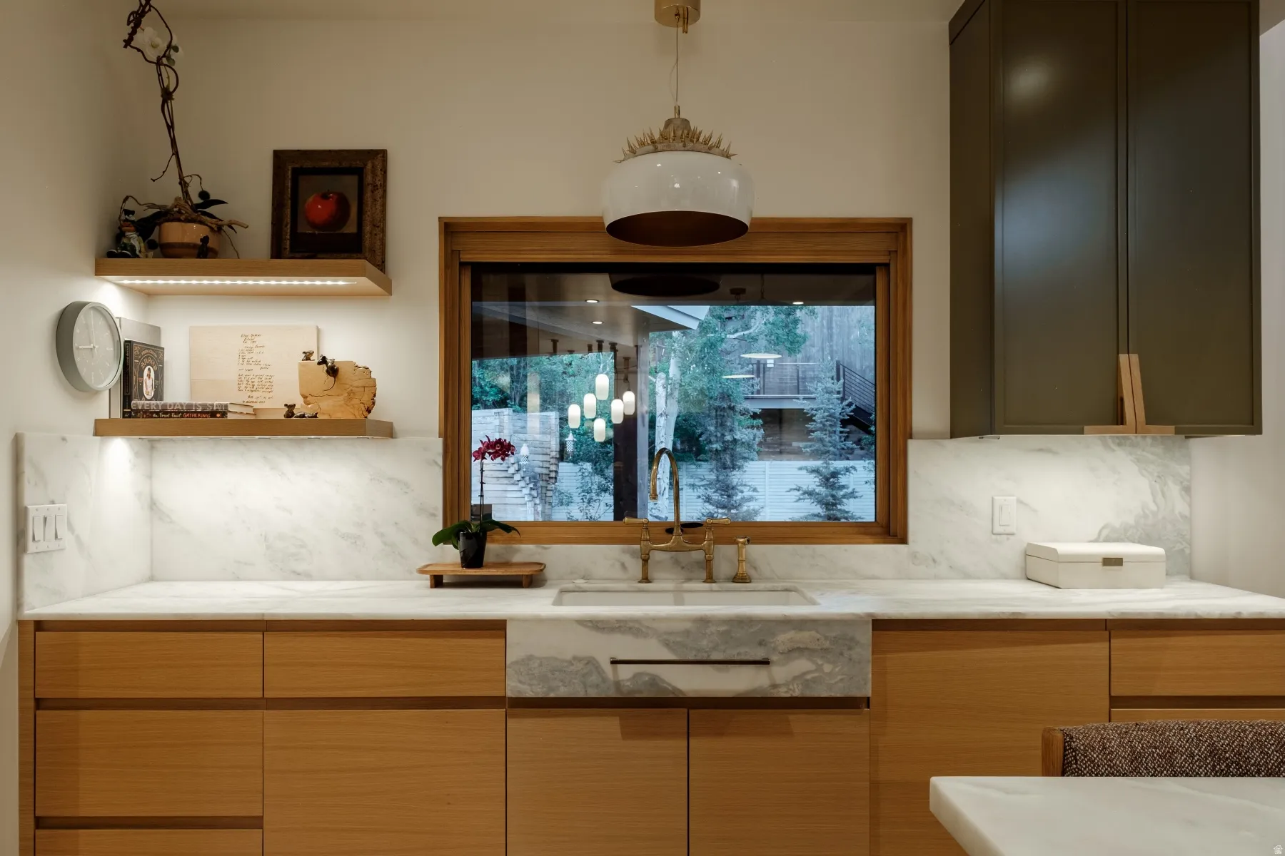 Kitchen featuring light wood cabinetry, stone countertops, and a matching stone farmhouse sink