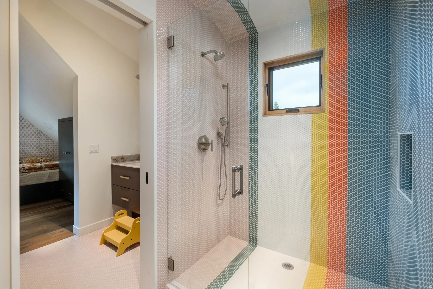 Shower with penny tile walls, integrated niche, and an accent window